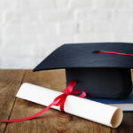 Mortar board and a graduation diploma