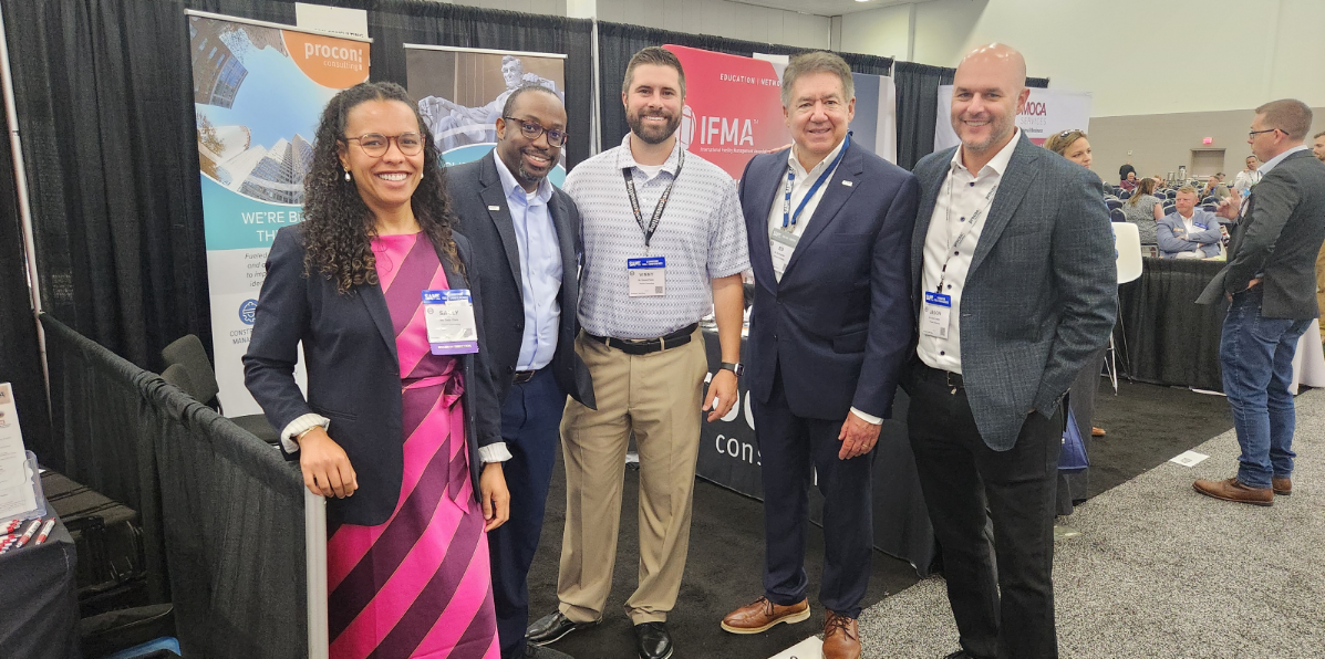 Leadership in front of Procon booth