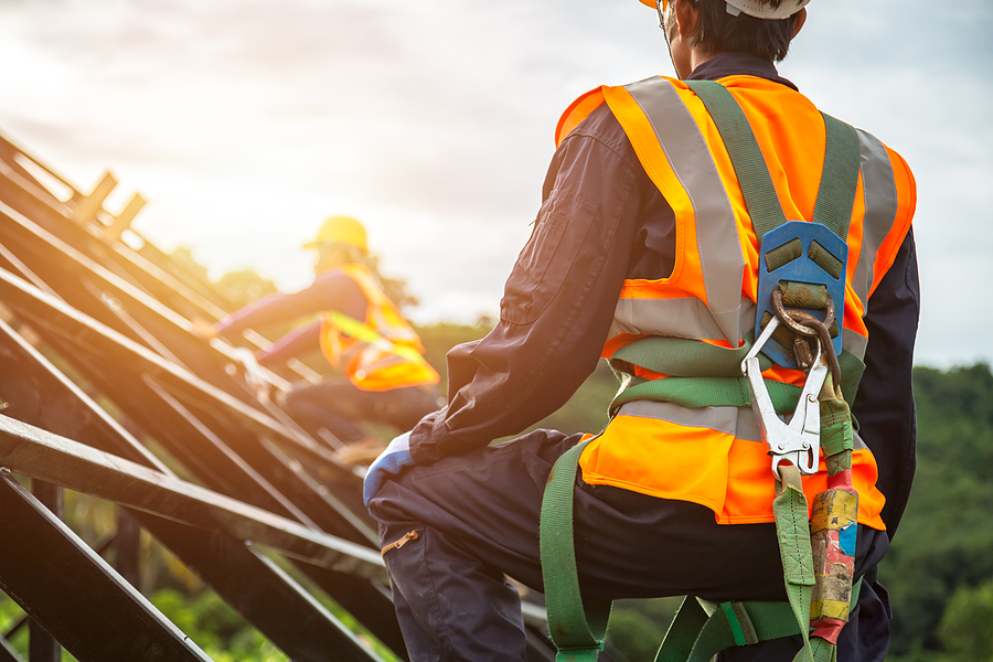 Two construction workers on a roof